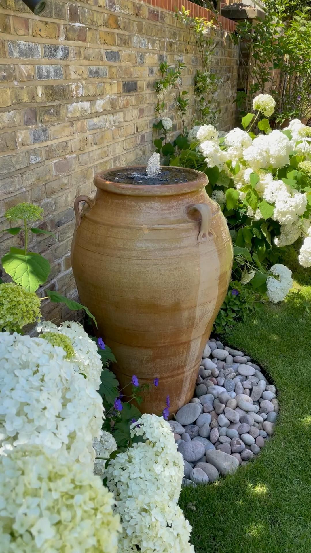 A Serene Oasis: A Small Garden Featuring
a Fountain