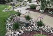 flower beds in front of house with rocks