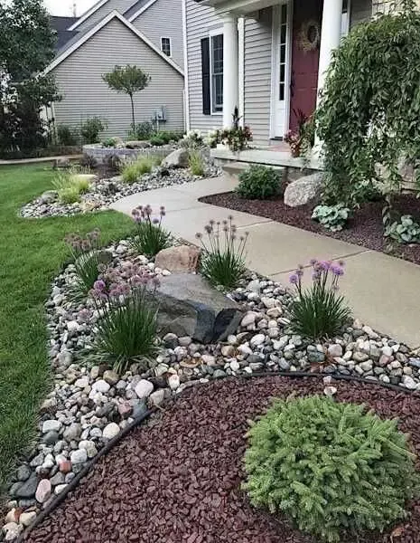 Beautiful Flower Beds Enhanced with Decorative Rocks Add Charm to Your Home Exterior