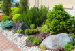 flower beds in front of house with rocks