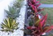 flower beds in front of house with rocks