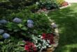 flower beds in front of house with rocks