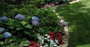 flower beds in front of house with rocks