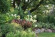 flower beds in front of house with rocks