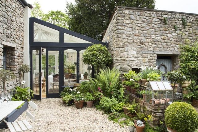 Courtyard garden boasts stone walls, scented plants and potted .