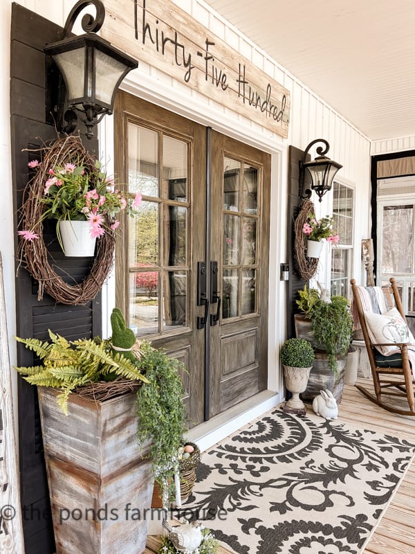 Farmhouse Porch Ideas for Spring with faux flowers and greene