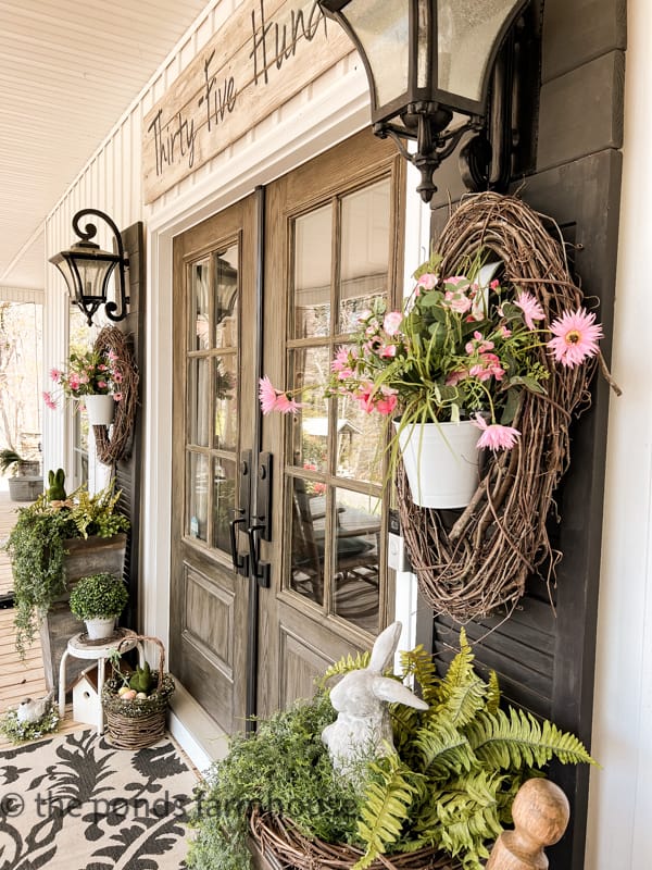 Farmhouse Porch Ideas for Spring with faux flowers and greene