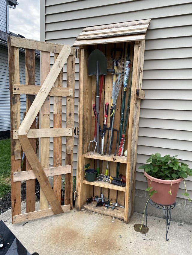 Garden tool storage cabinet made with weathered pallet planks and .