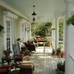 Charming Front Porch with Rocking Chairs and Potted Plan