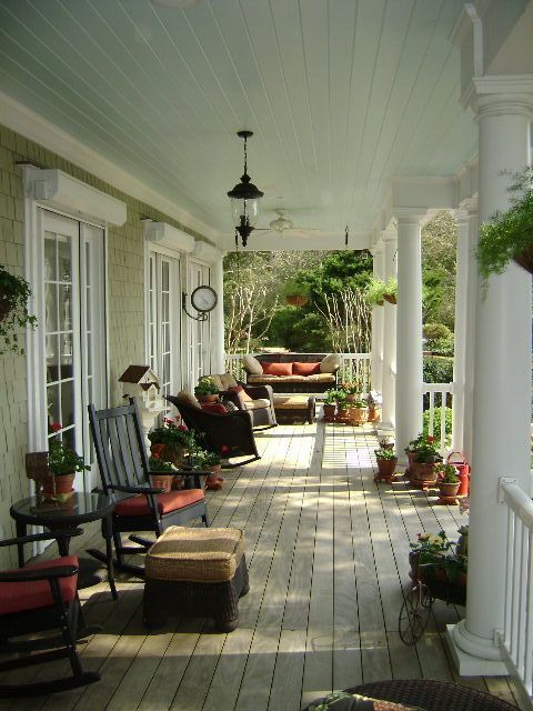 Charming Front Porch with Rocking Chairs and Potted Plan