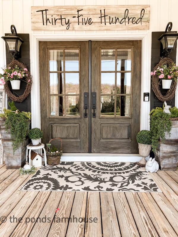 Farmhouse Porch Ideas for Spring with faux flowers and greene